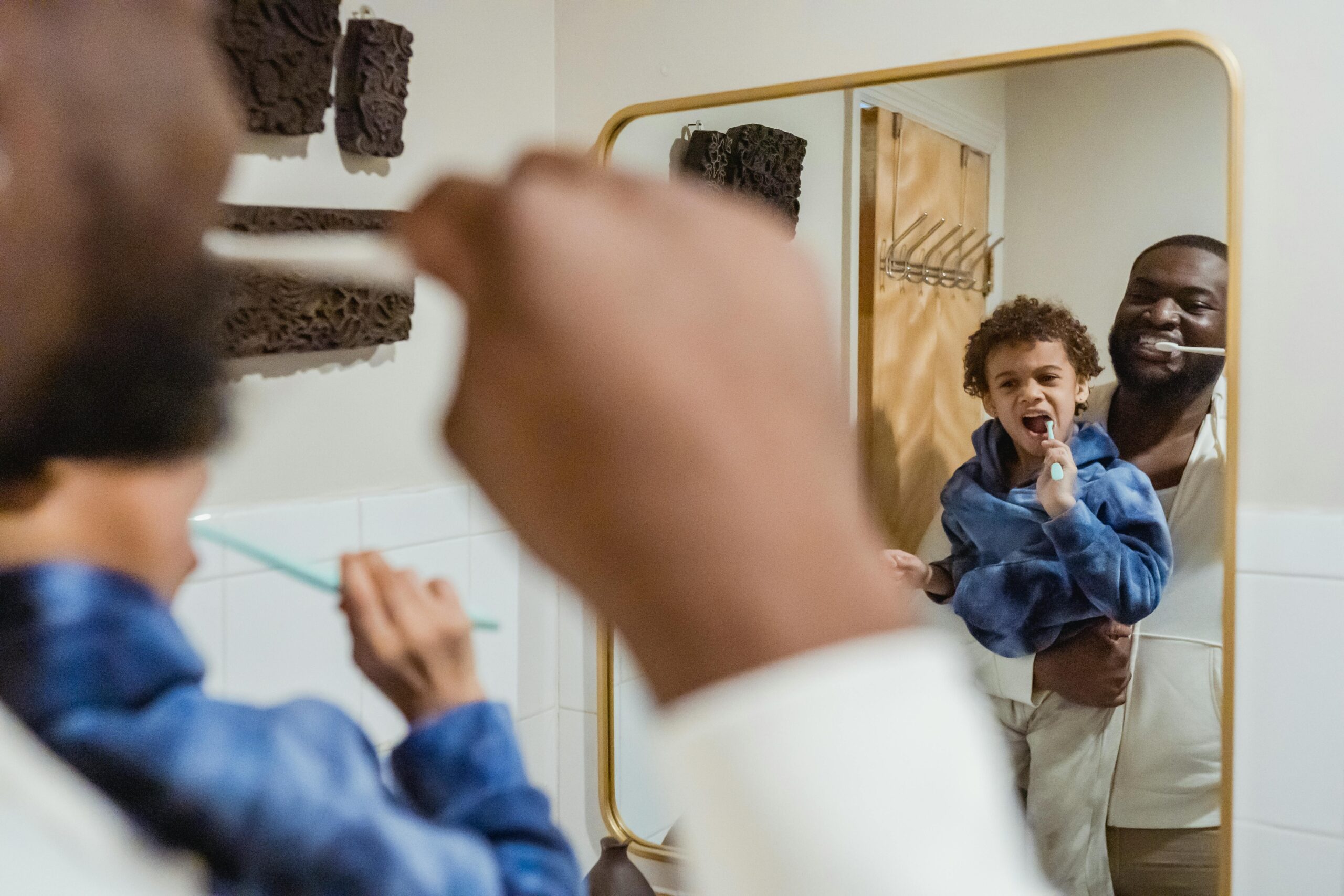 father son brushing teeth