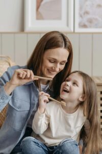 mother and daughter brushing teeth