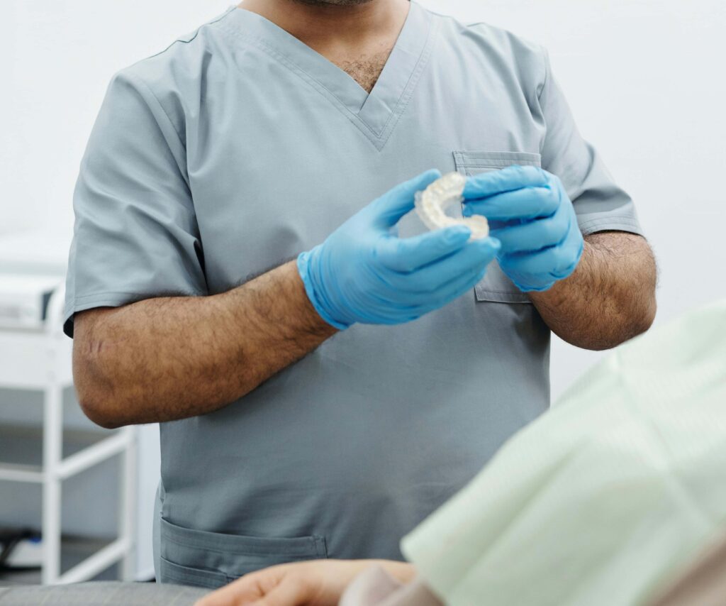 orthodontist holding retainers